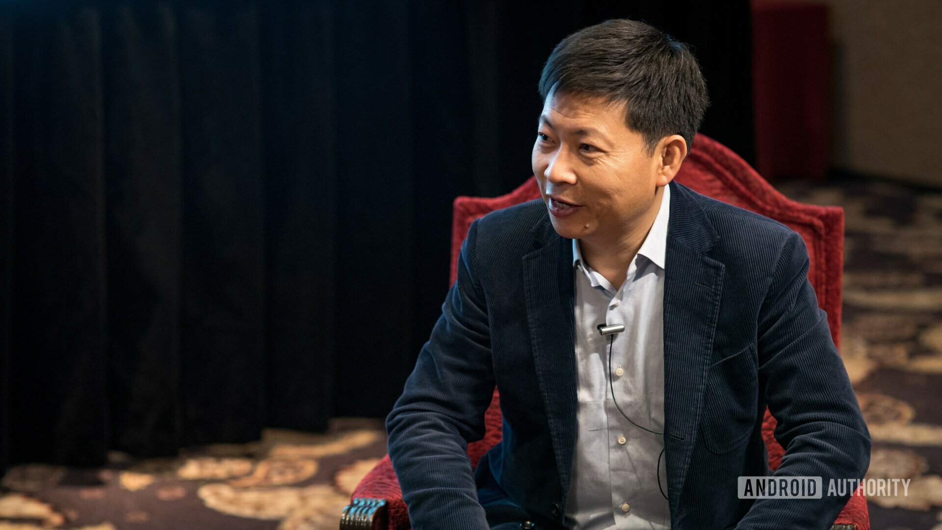 Huawei consumer business group CEO Richard Yu on a red chair. 