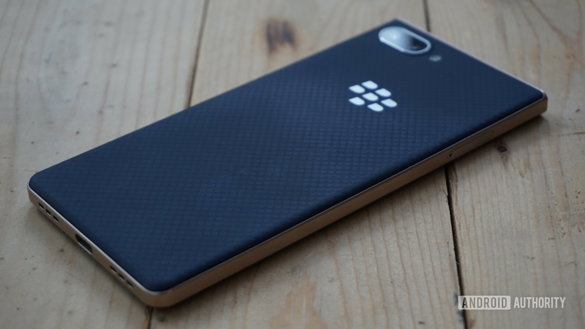 Back side of the BlackBerry Key2 LE on a wood table.