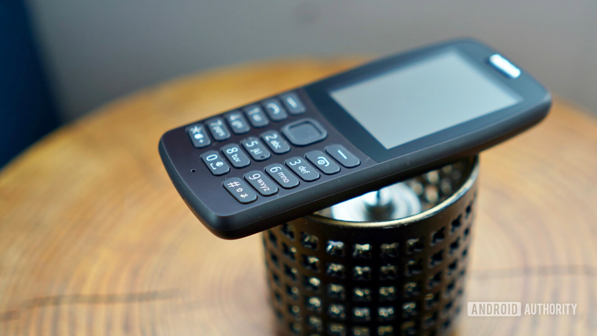 Nokia 210 on top of a candle.