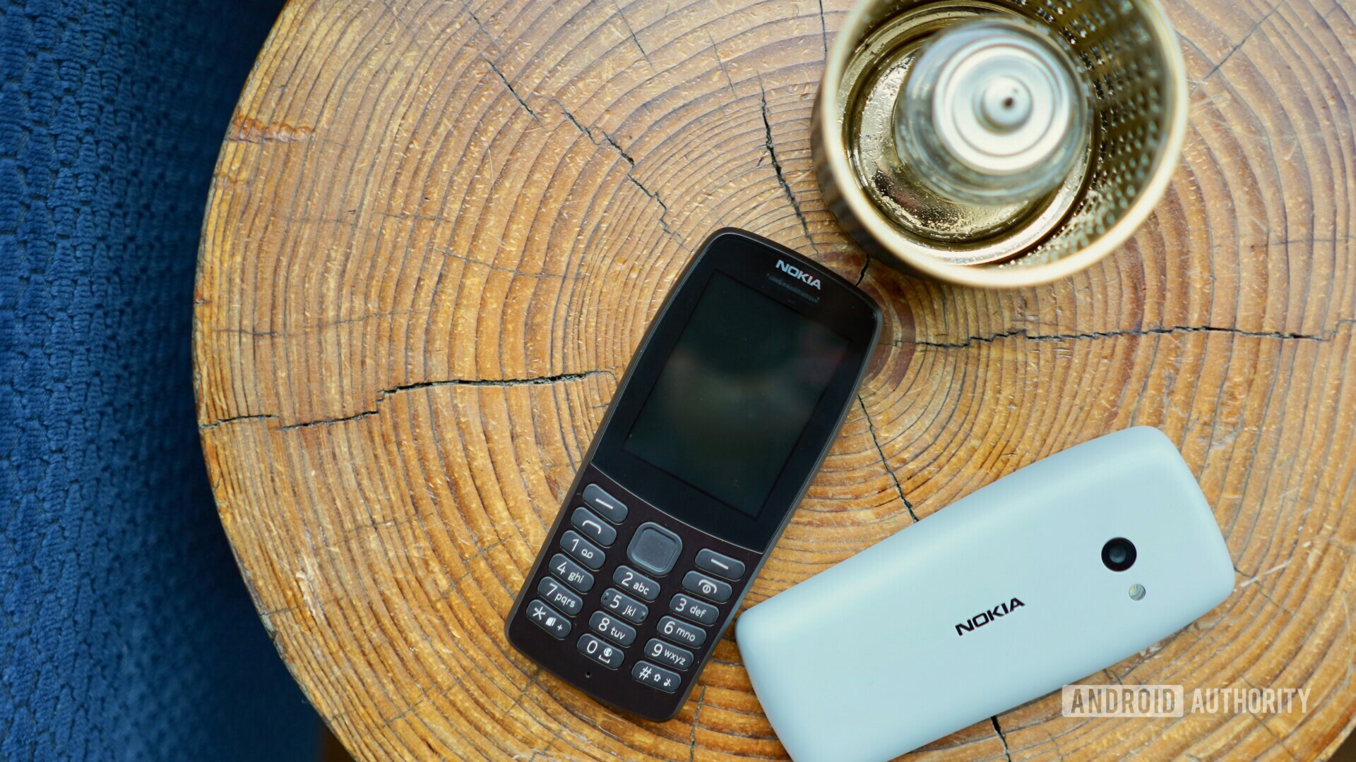 Front and back side of Nokia 210 laying on a table.