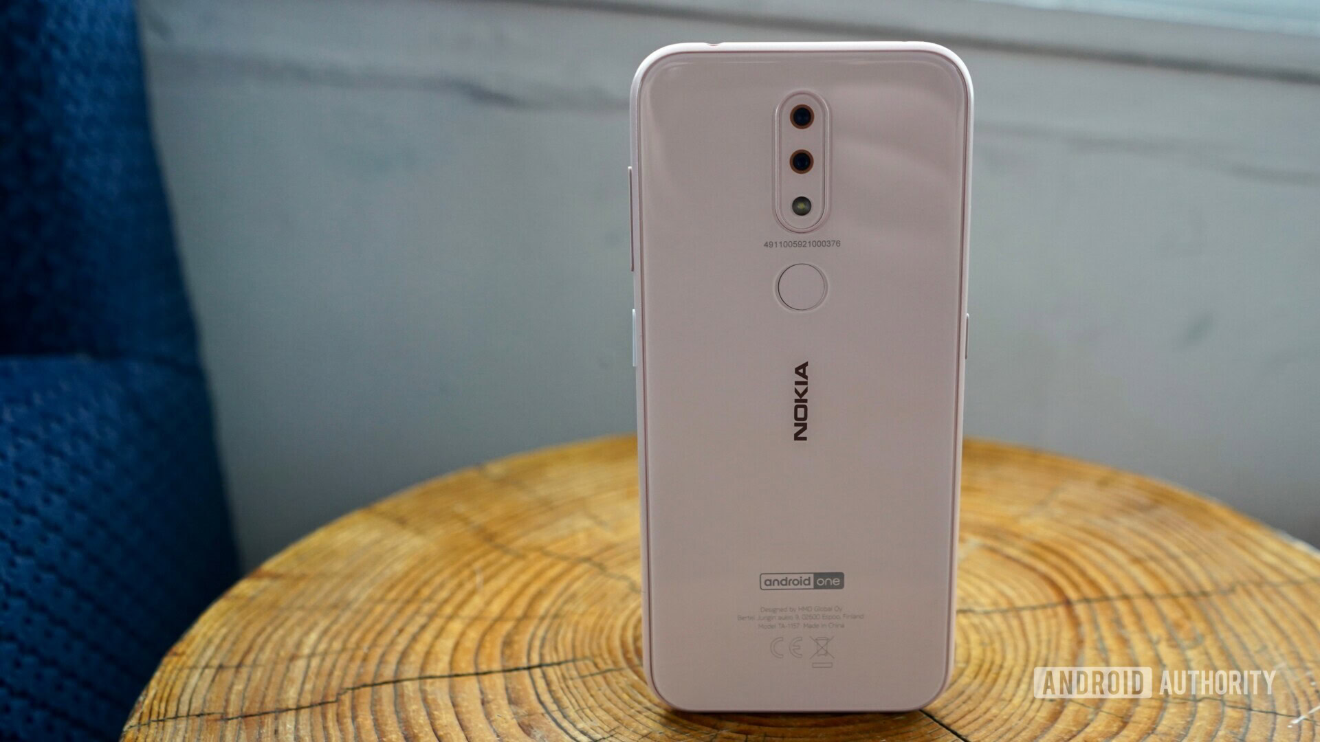 Backside photo of a white Nokia 3.2 standing up right.