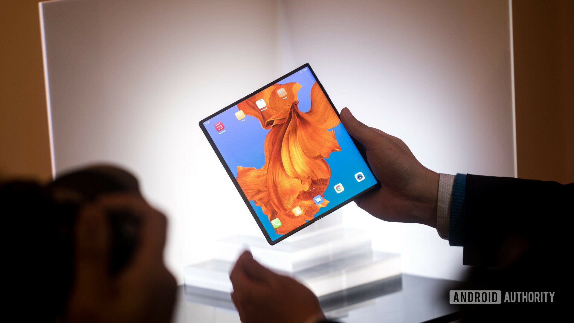 Huawei Mate X in tablet mode featuring an 8&quot; display, held in a hand at MWC 2019 presentation.