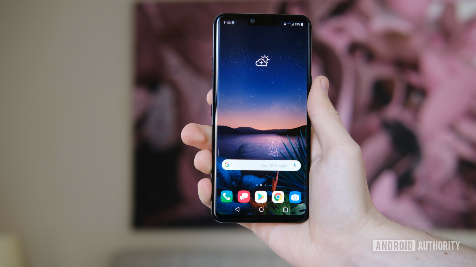 Front side of the LG G8 ThinQ held in a hand.