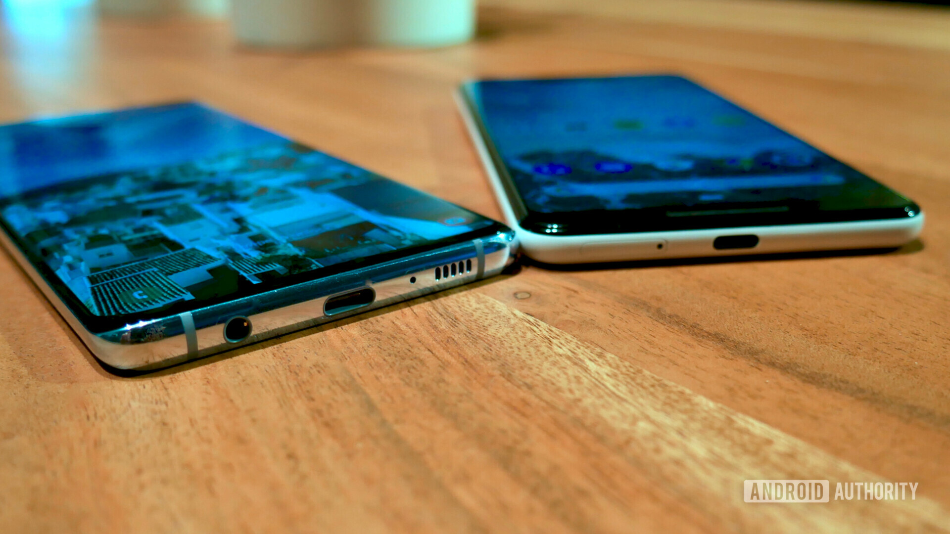 Bottom side photo of the Samsung Galaxy S10 Plus next to a Google Pixel 3 XL showing the USB-C and headphone jack