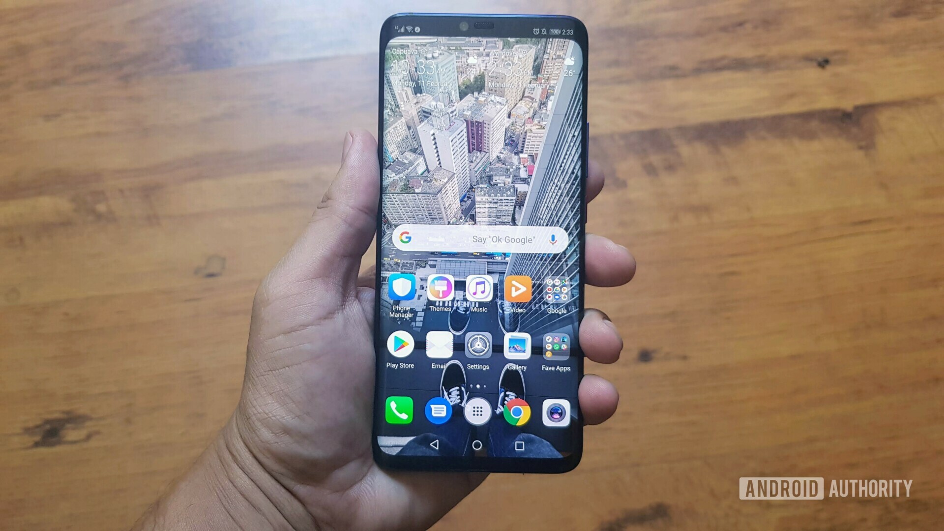 Front side photo of The Huawei Mate 20 Pro held in a hand with a display turned on.