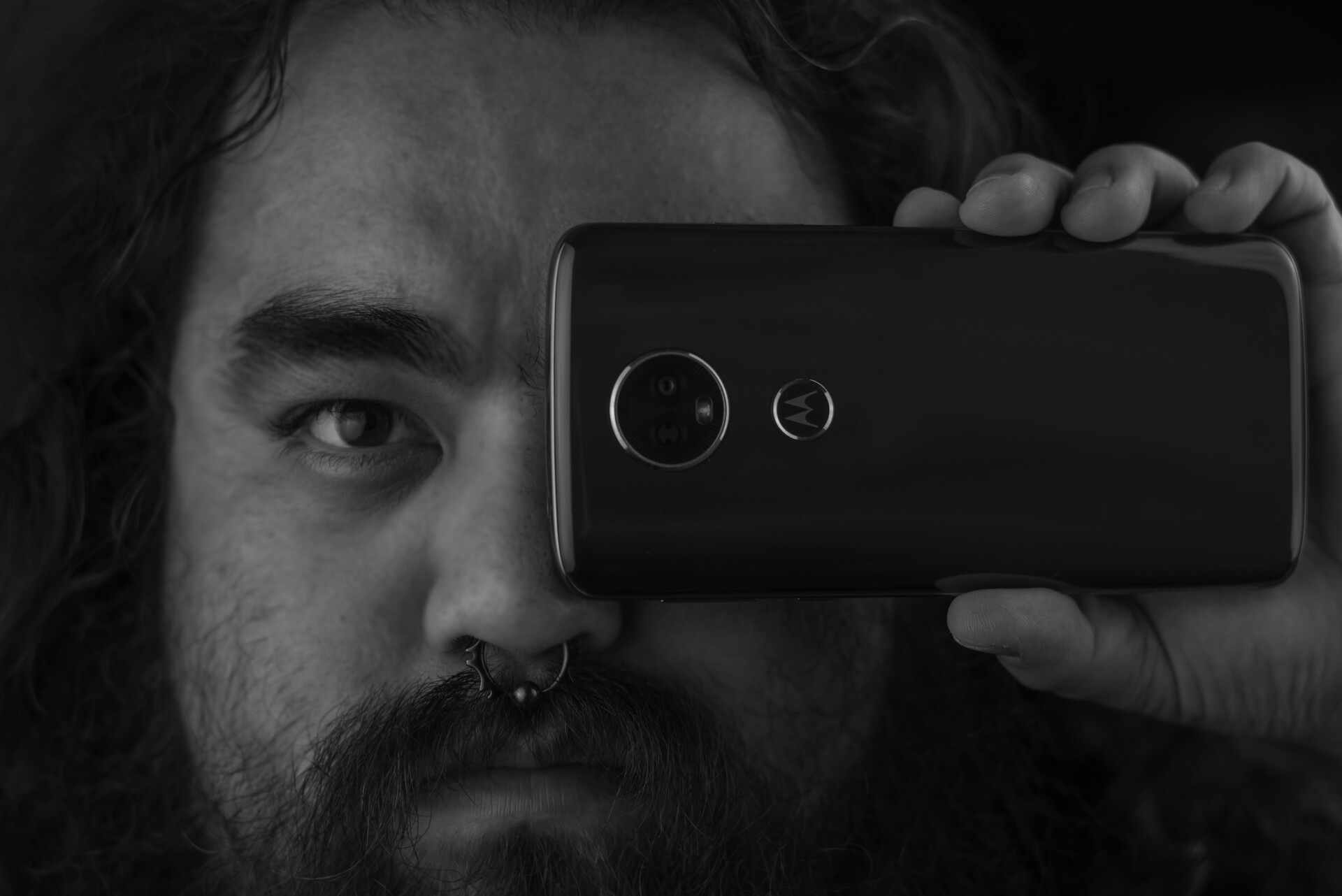 Edgar holding a budget camera phone