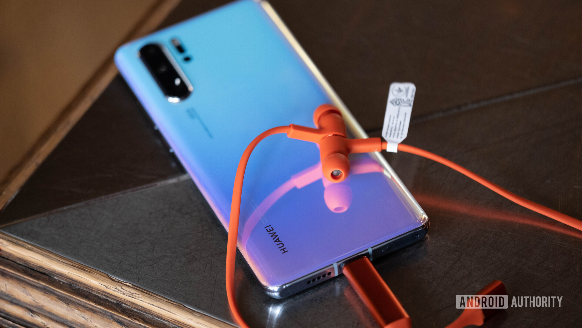 HUAWEI Freelace earbuds resting on HUAWEI P30 Pro, connected to the phone.