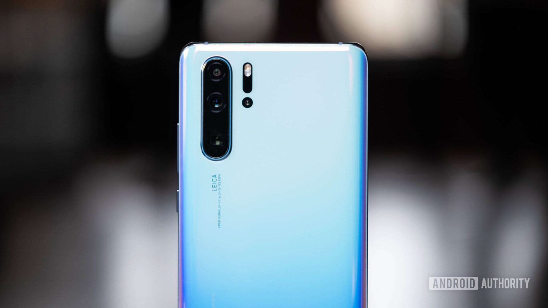 Backside of a White HUAWEI P30 Pro showing the rear cameras.