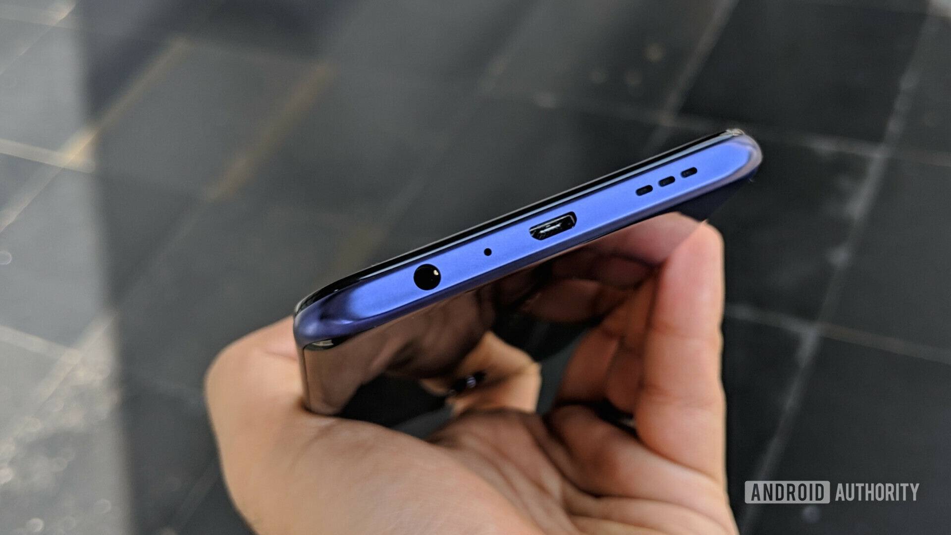 Bottom side of the oppo f11 pro showing the micro USB and headphone jack