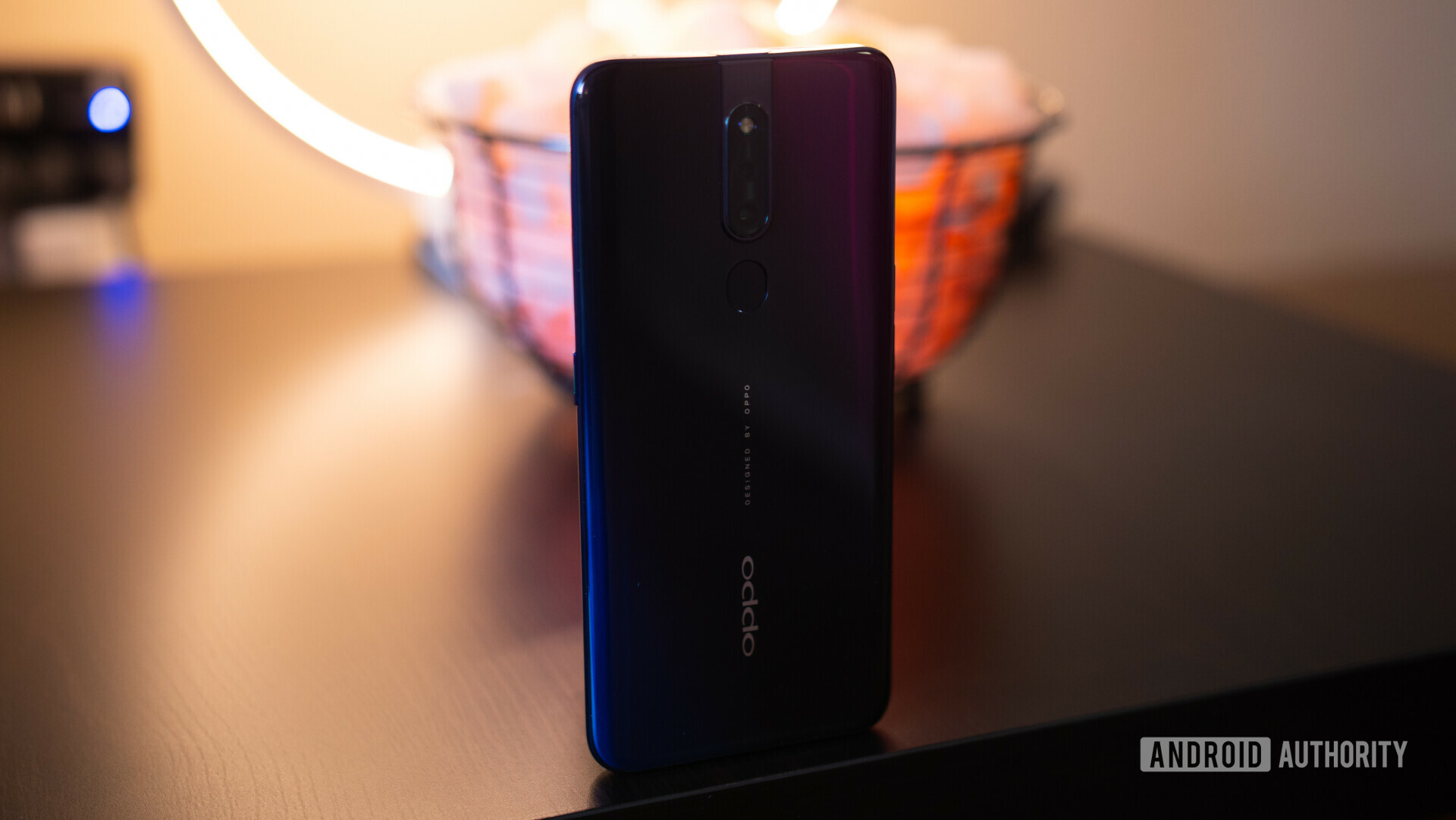 Back side view of the OPPO F11 Pro rear glass panle, standing upright on a table.