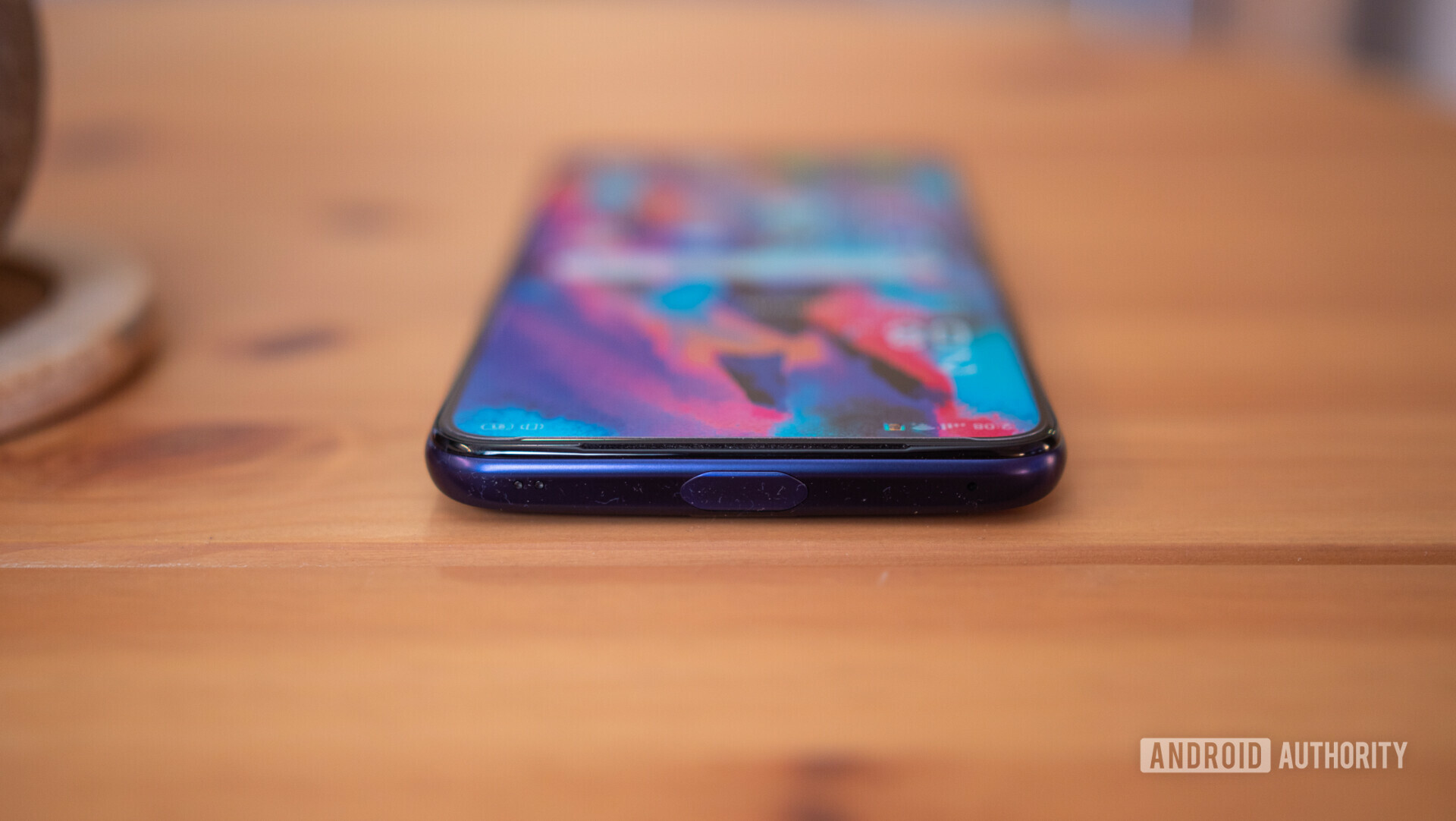 Top side view of the OPPO F11 Pro laid on a desk.