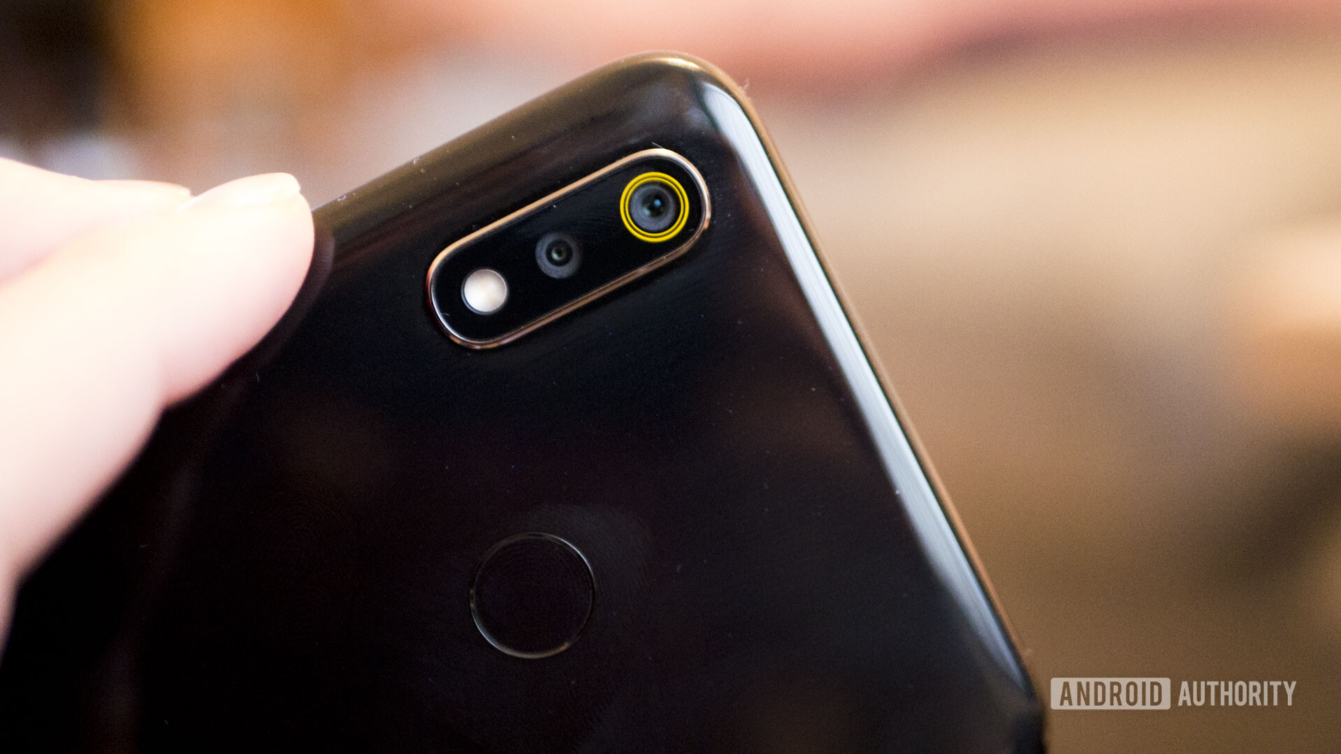 Backside of the Realme 3 focusing on the fingerprint sensor.