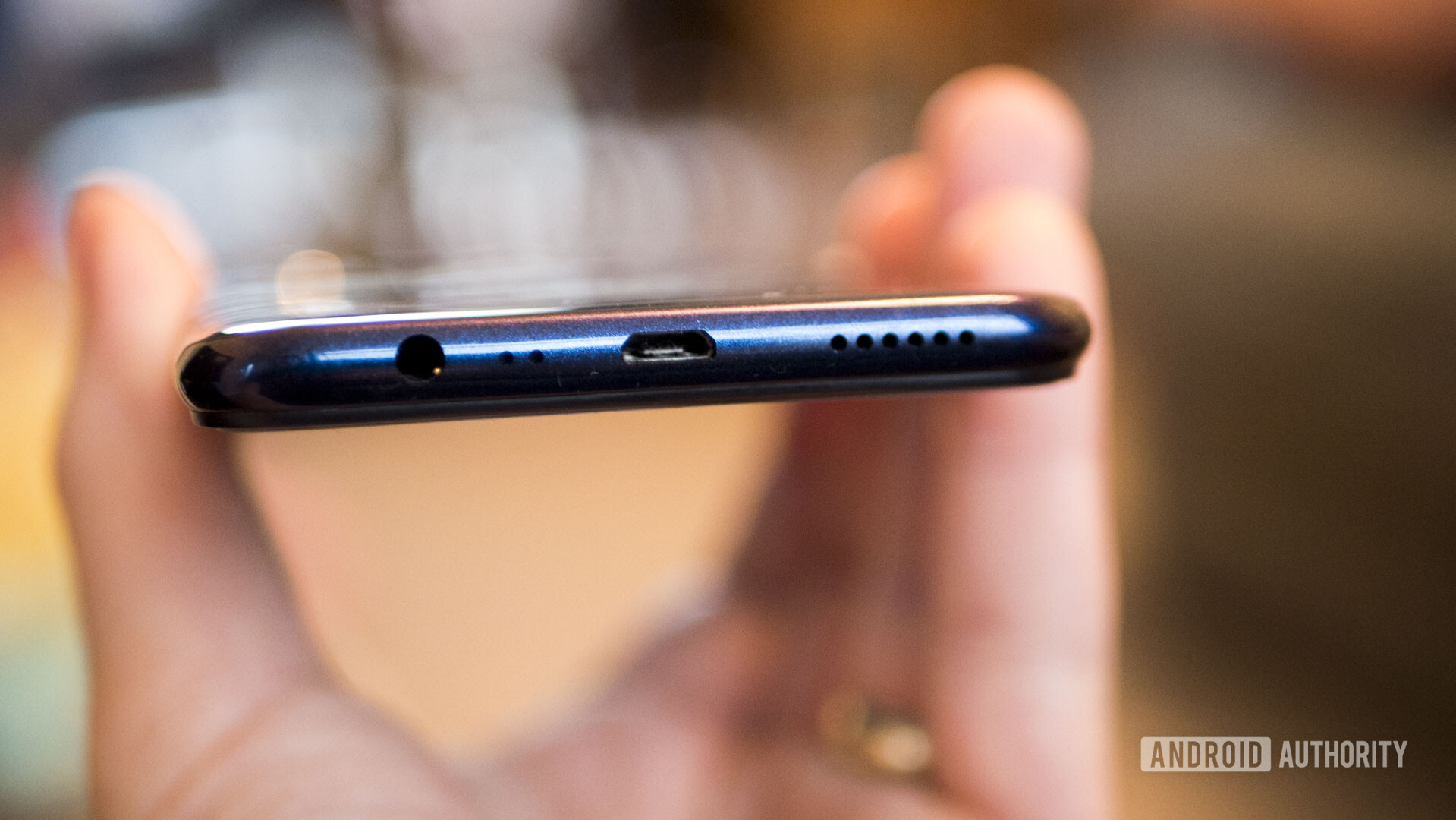 Bottom side of the Realme 3 showing the microUSB, headphone jack and speaker grill.
