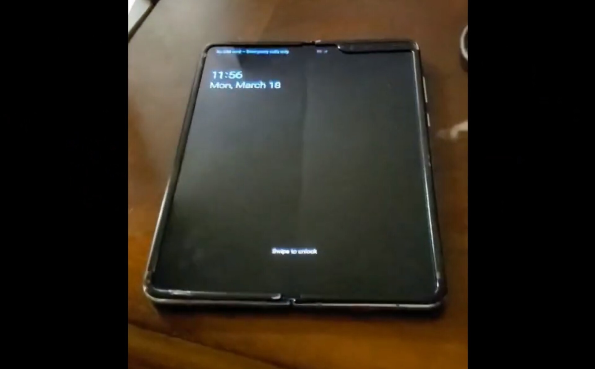 A leaked video supposedly showing the Samsung Galaxy Fold on a table, face-up, with a visible crease in the middle of the screen.