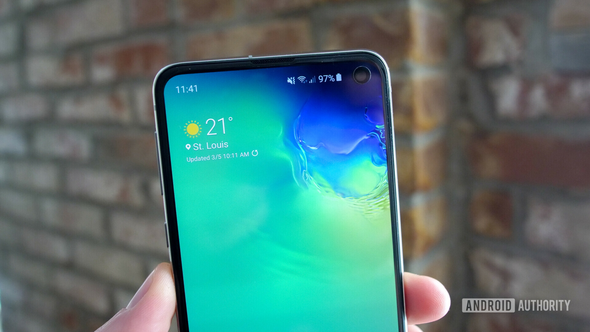 Front upper side of the samsung galaxy s10e focusing on the display hole punch camera.