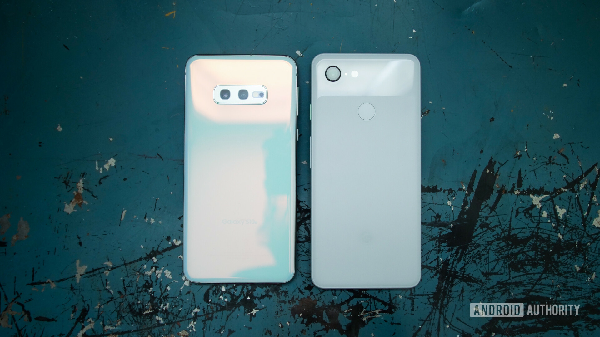 Backside of Samsung galaxy s10e next to a google pixel 3 in white color
