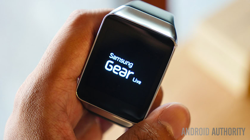 A photograph of a hand holding the Samsung Gear Live smartwatch.