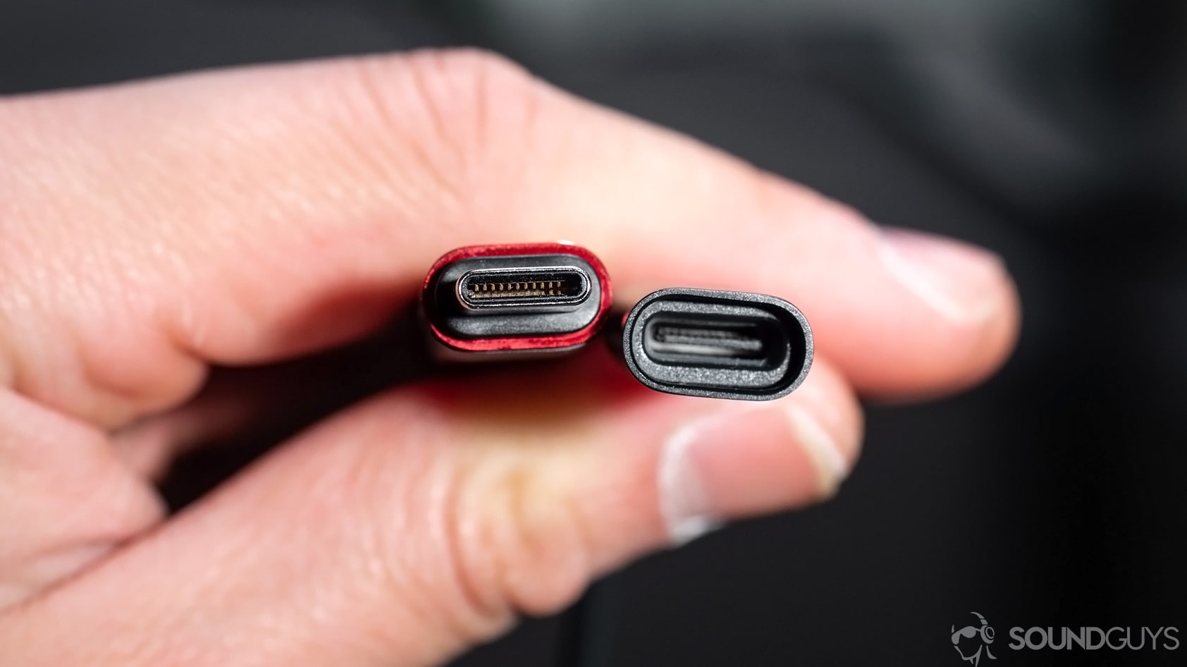Huawei Freelace: A close-up of the USB-C module built into the neckband. The pieces are held in a hand to show the male and female ends.