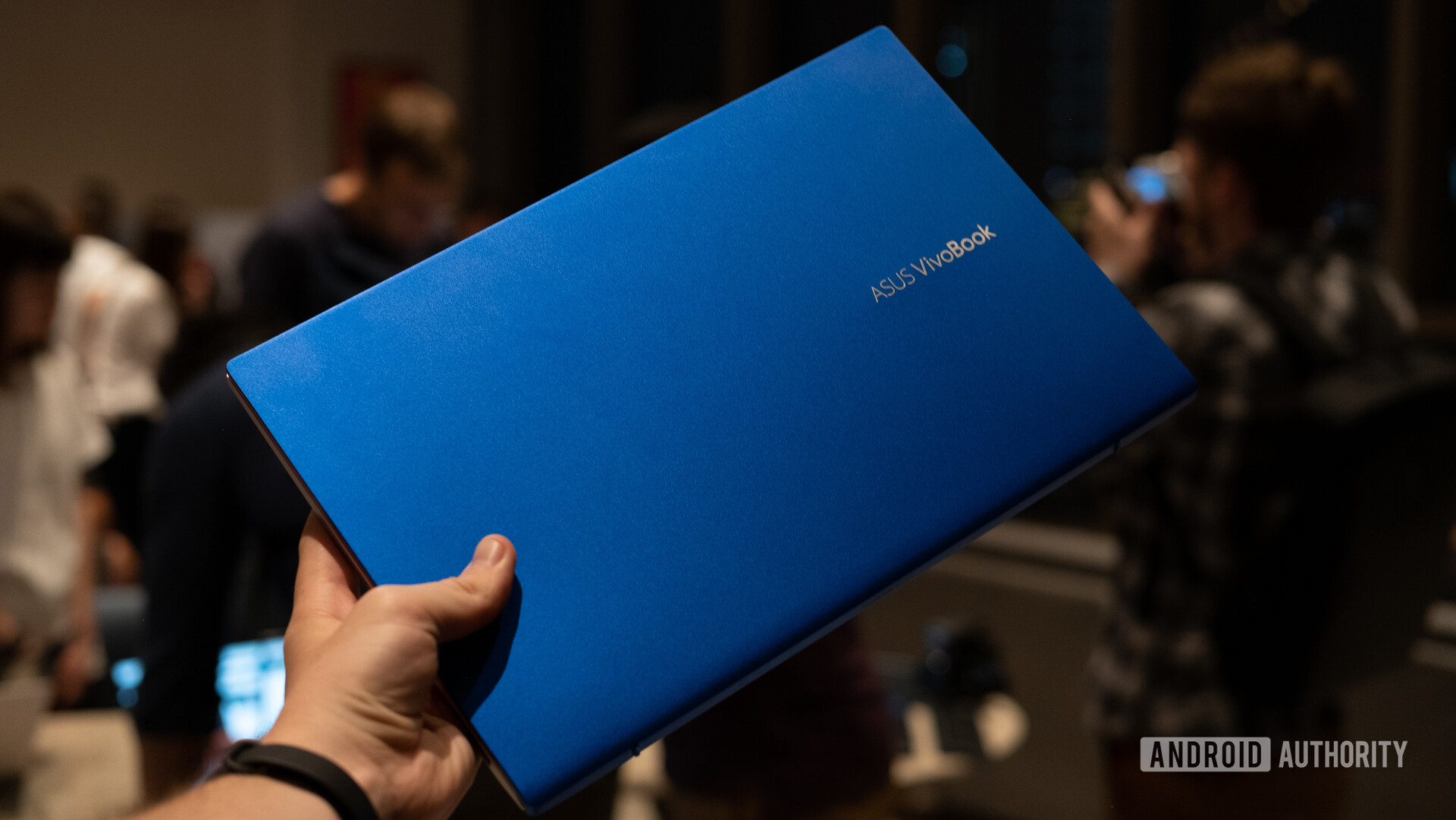 The ASUS Vivobook in hand.