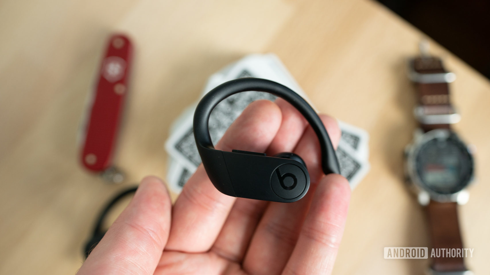 A picture of the Beats Powerbeats Pro in a man's' hand.