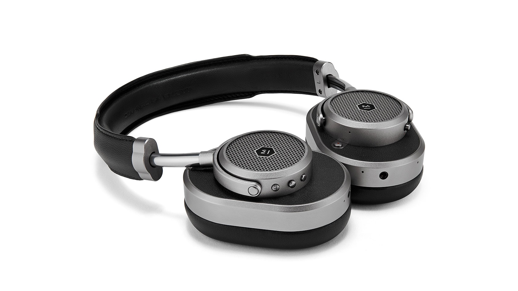 Master &amp; Dynamic MW65 noise cancelling headphones in black lying flat on a white background.