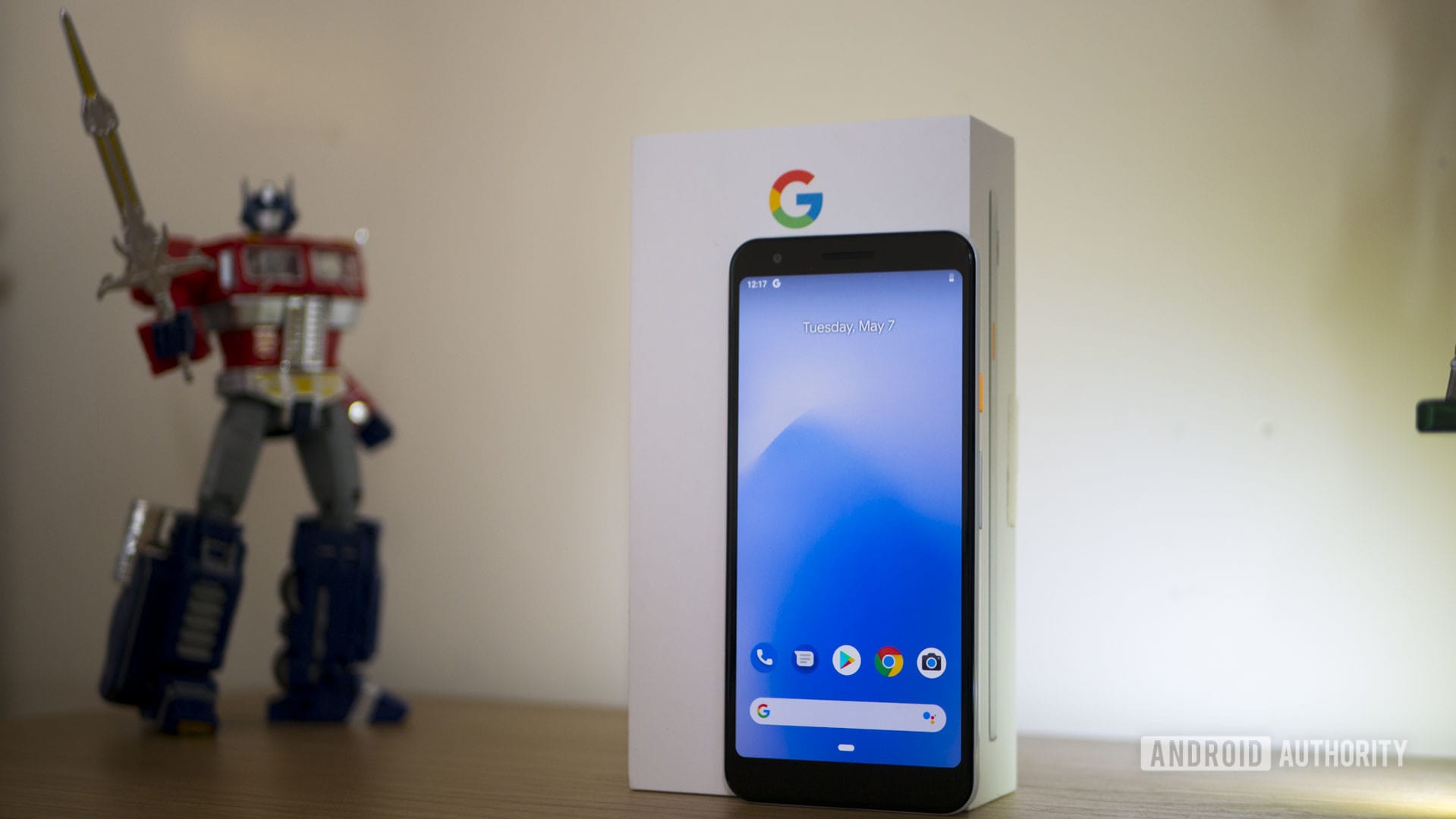 Pixel 3a handset standing on a table in front of its retail box. 