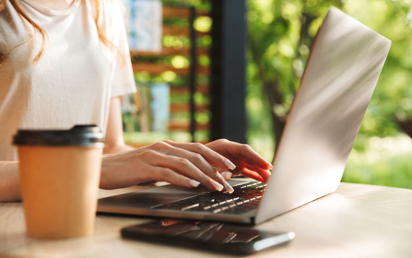 Woman Typing or Coding on Laptop Outside