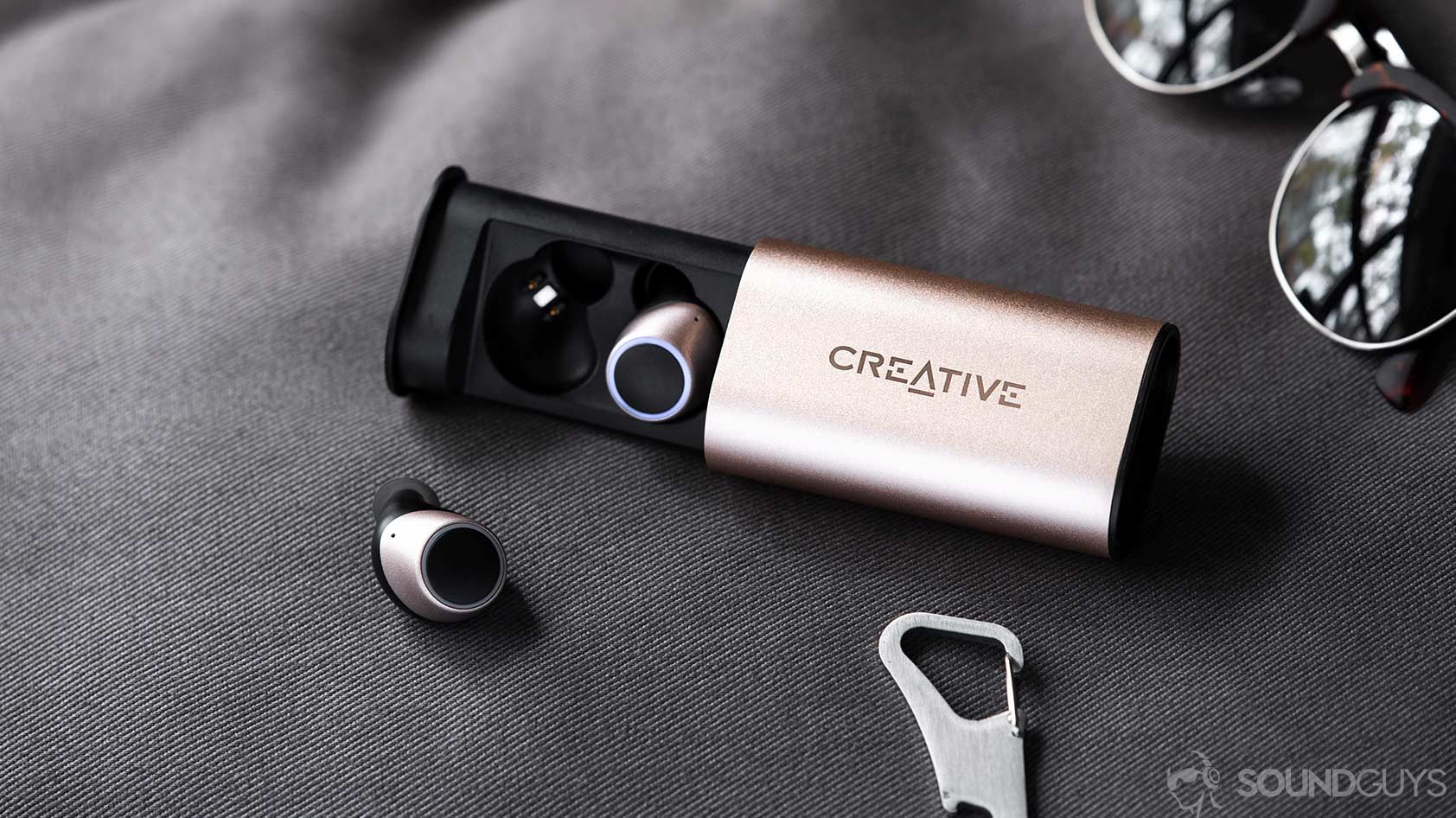 Creative Outlier Gold charging cases open earbuds in out
