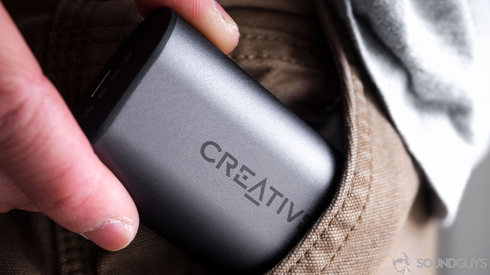 The Outlier Air charging case being inserted into a pocket.