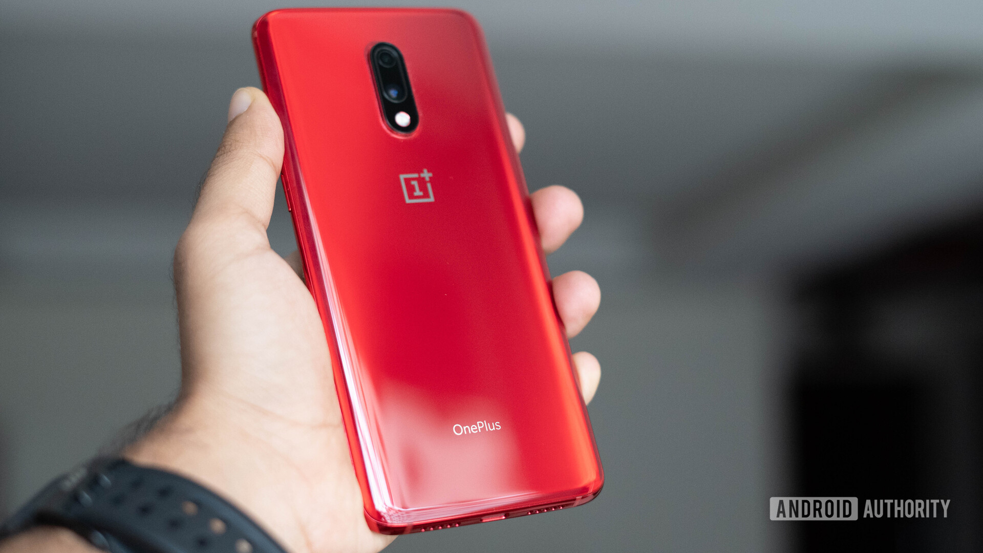 OnePlus 7 in red in a hand. OnePlus 7 versus OnePlus 6T.