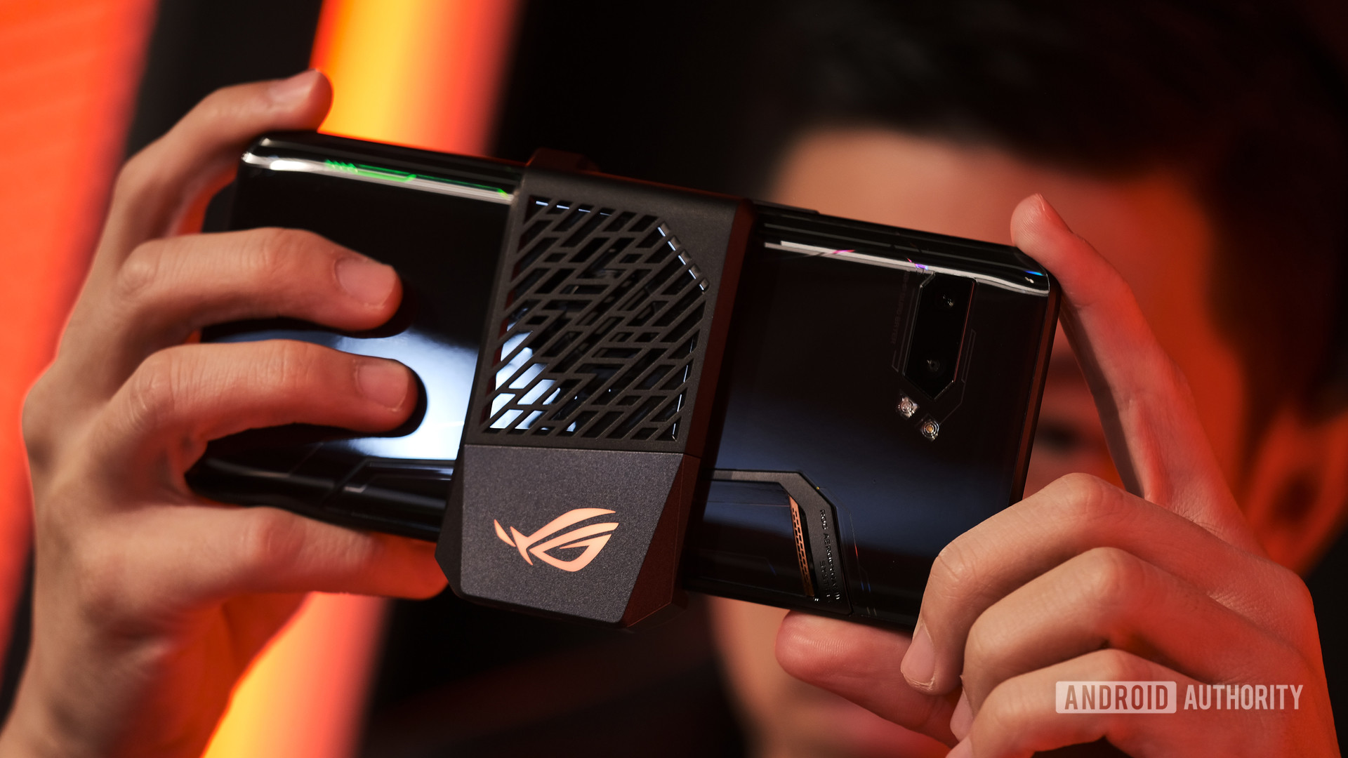 ASUS ROG Phone 2 gaming with external fan module at angle