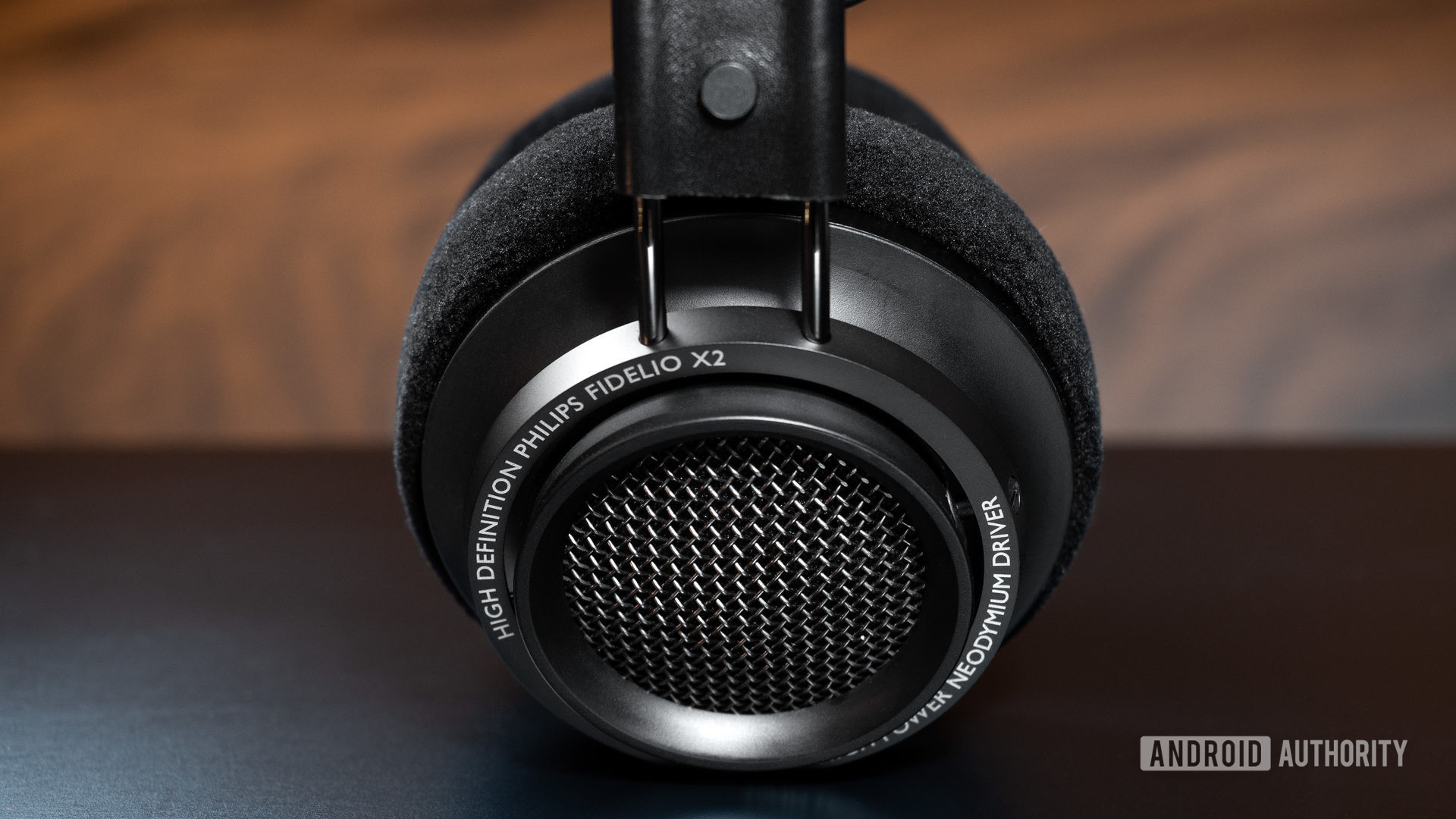 Philips Fidielio X27 open-back headphones on a black table.