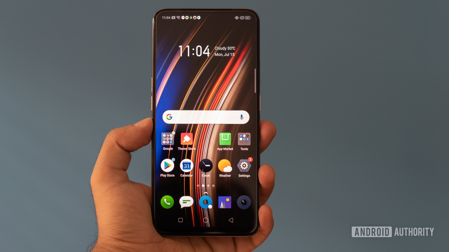 realme X in hand with homescreen display