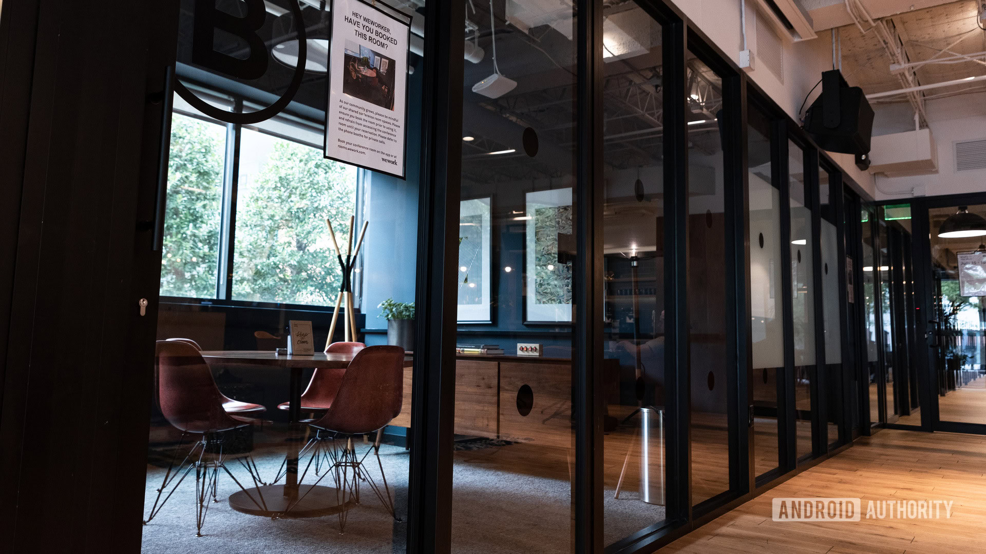 An image of a conference room at WeWork behind glass windows.