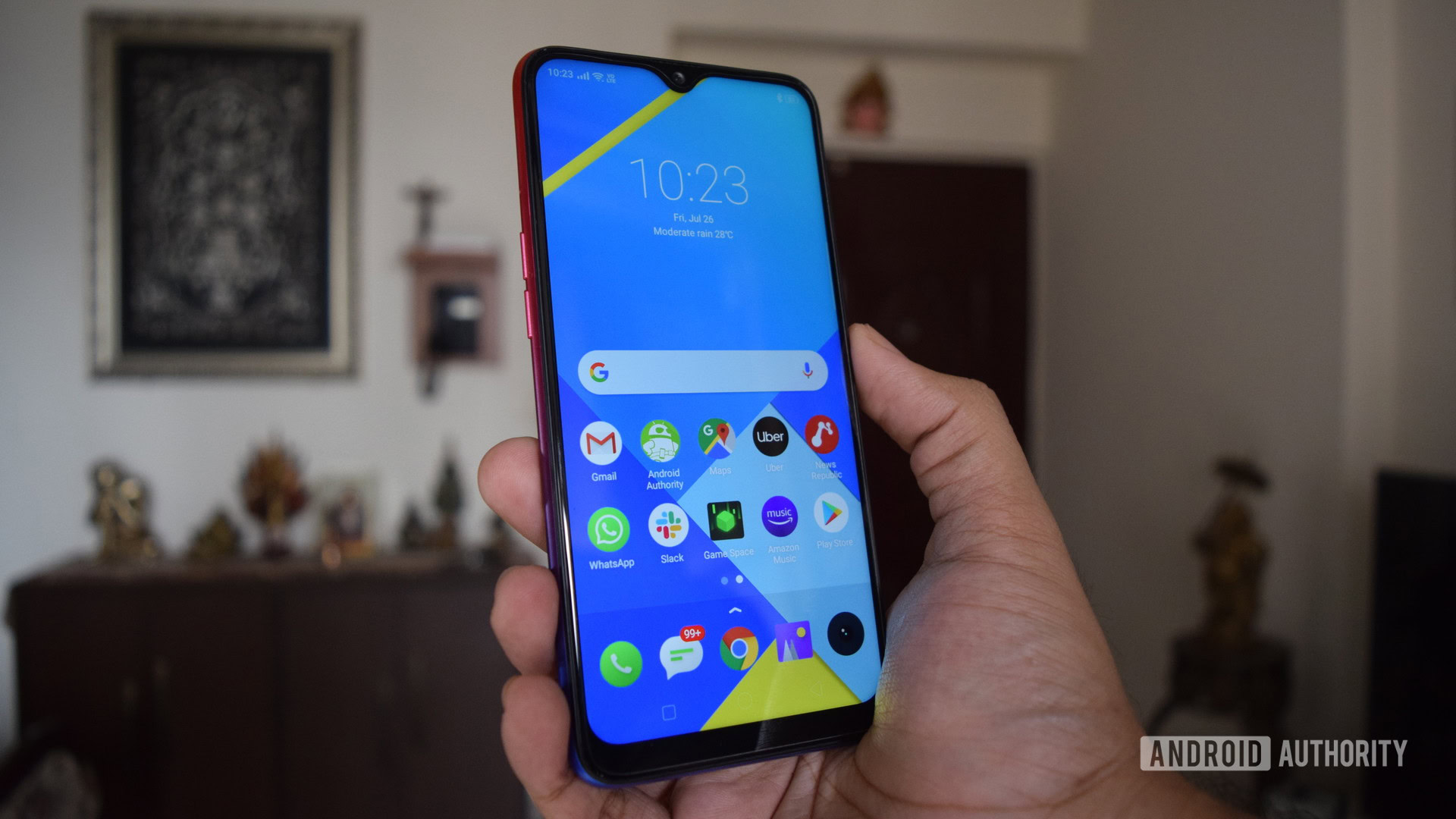 realme 3i review phone in hand showing display