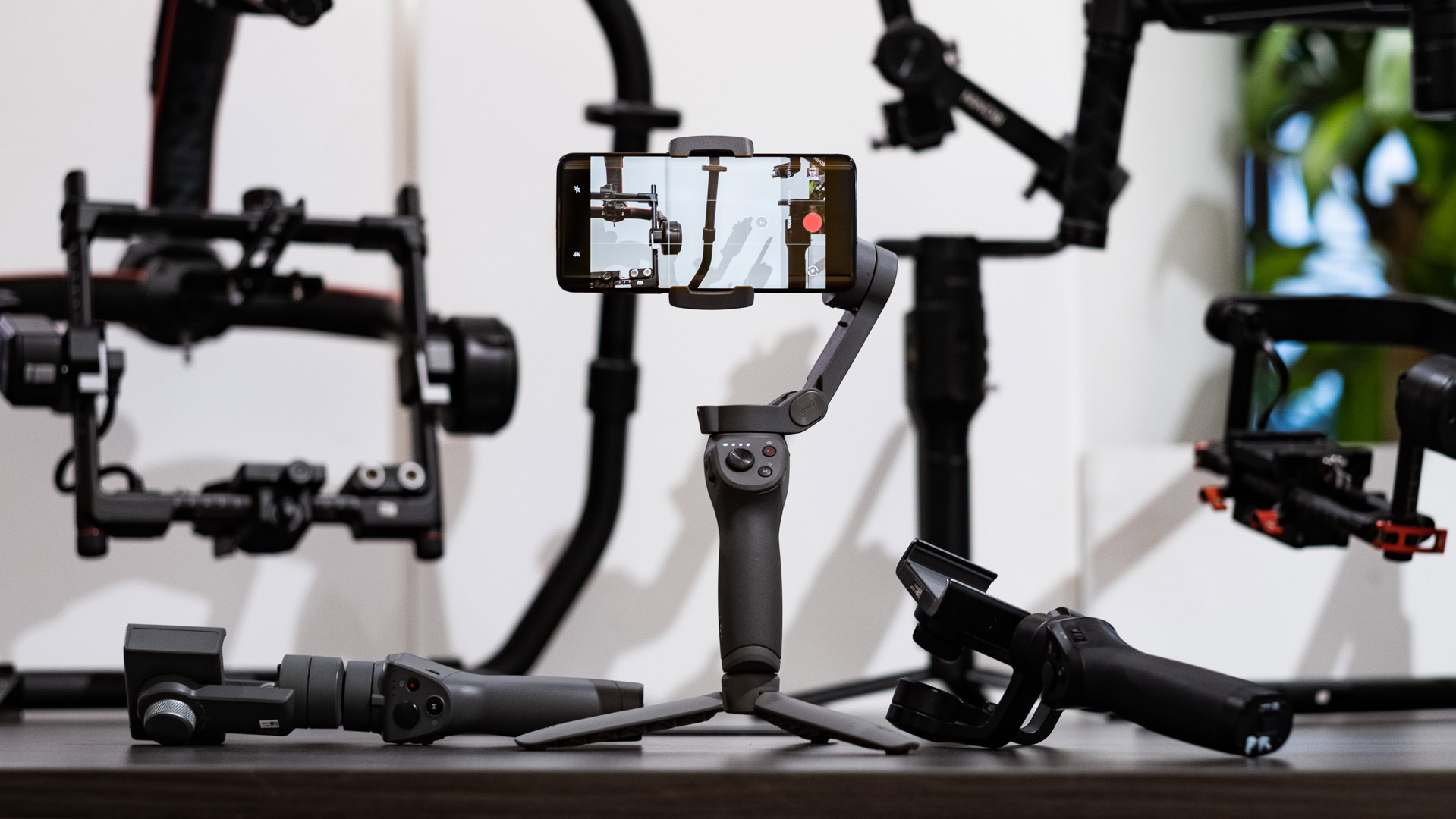 DJI Osmo Mobile 3 standing on table vs old Osmo Mobiles 2