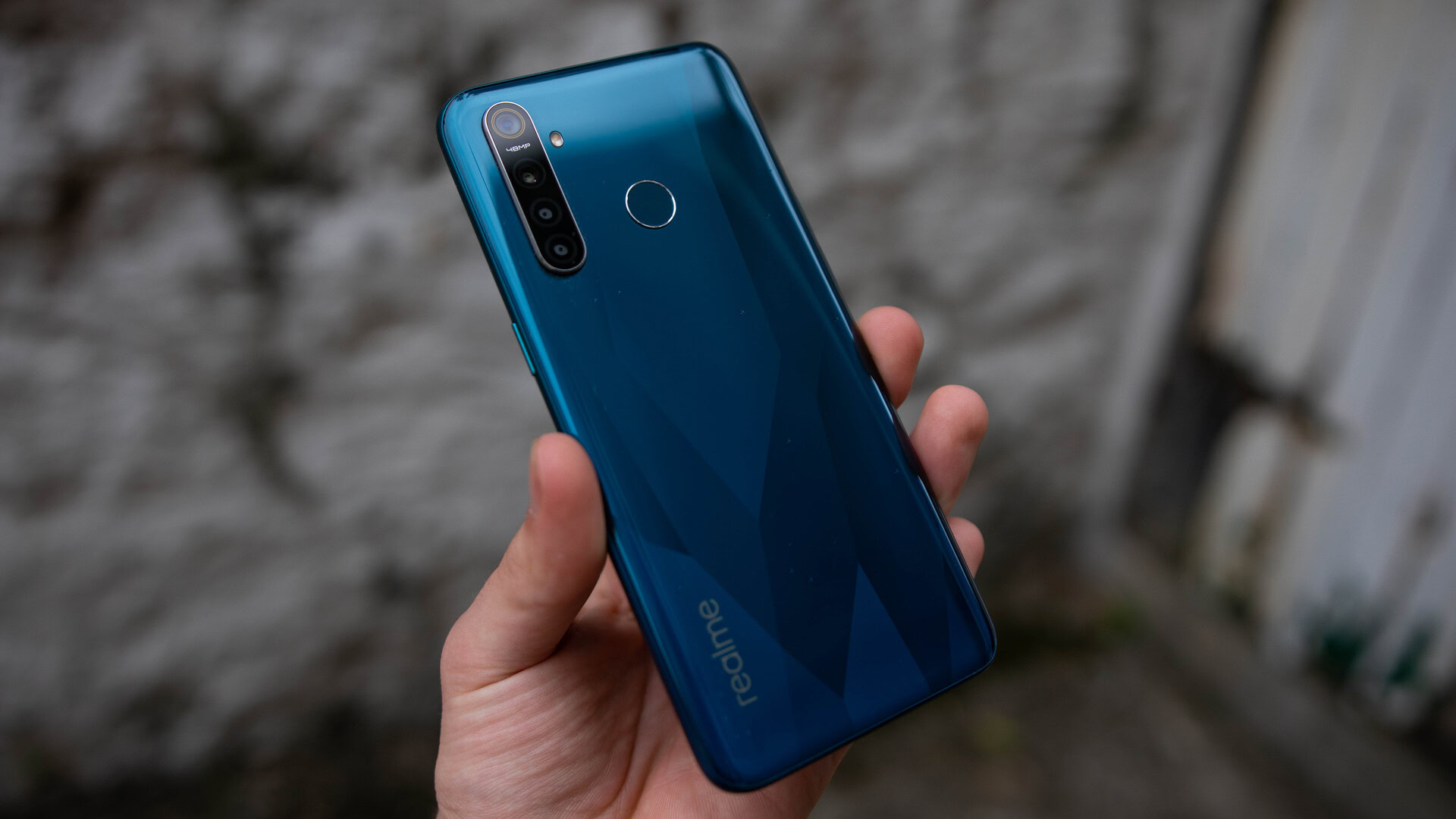 realme 5 Pro rear view in hand holding phone