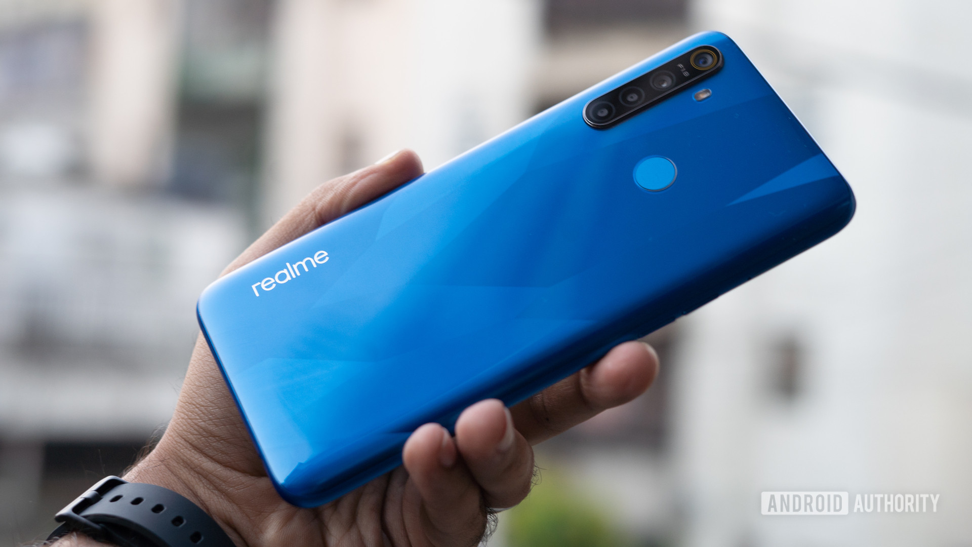 Realme 5 in hand showing back of phone