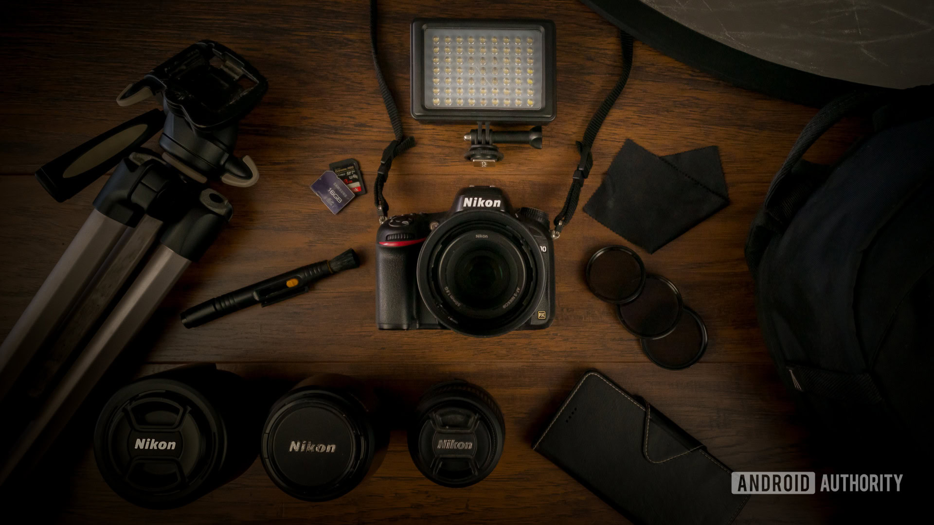 Photography gear including camera, tripod, reflector bag, microfiber pen, LED smartphone, SD cards, polarizers, ND filters. 2