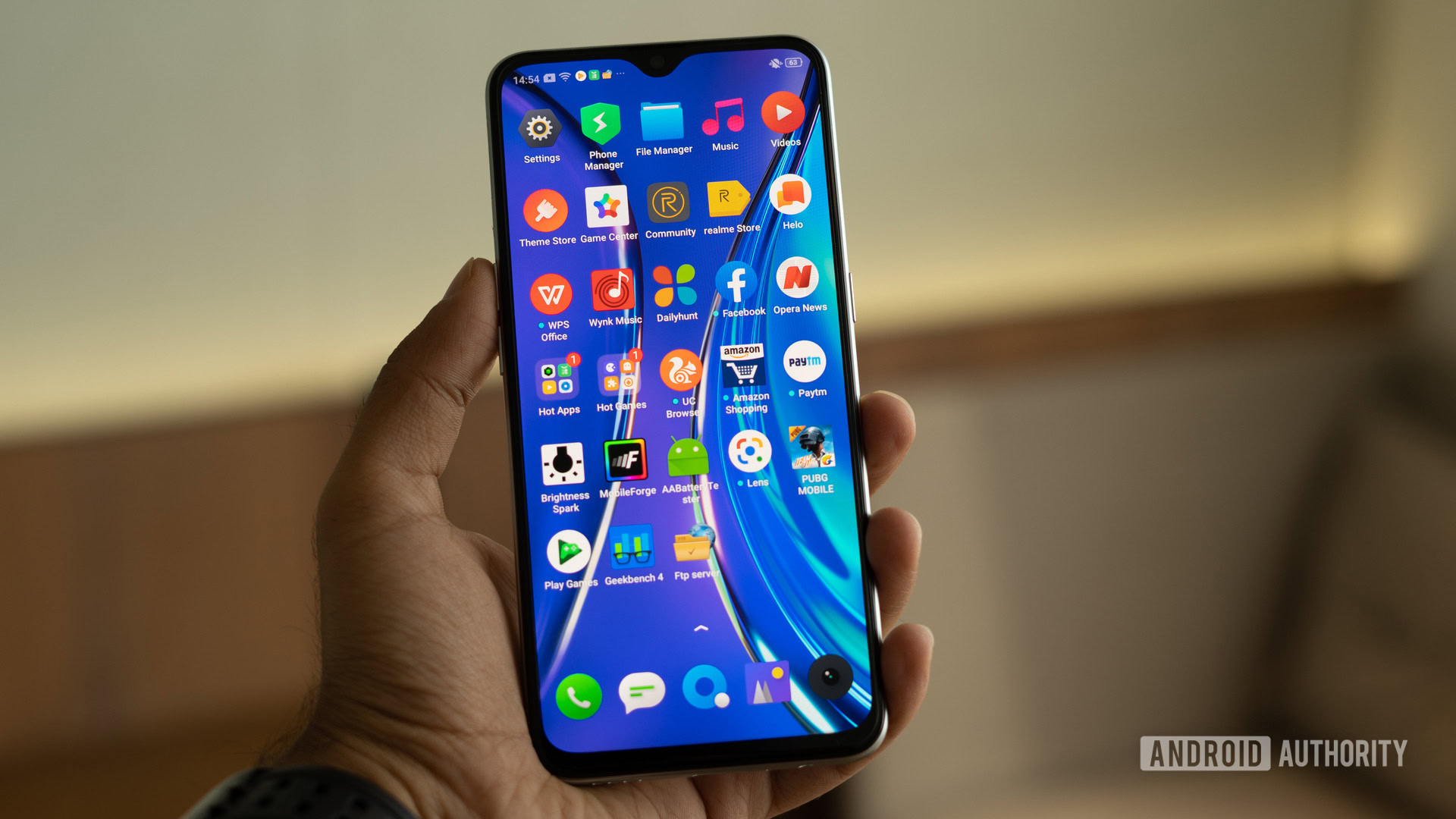 realme XT in hand with apps