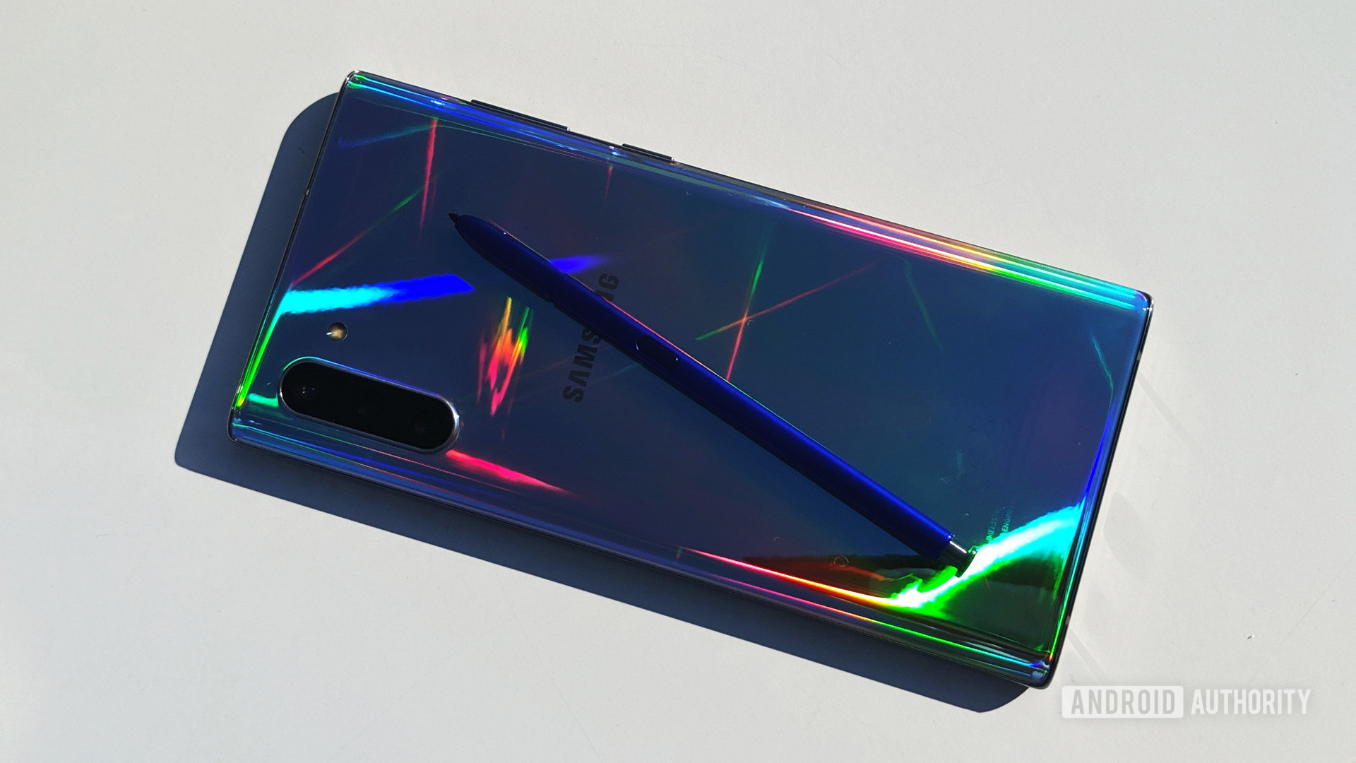 Samsung Galaxy Note 10 and S Pen on table with colored reflections