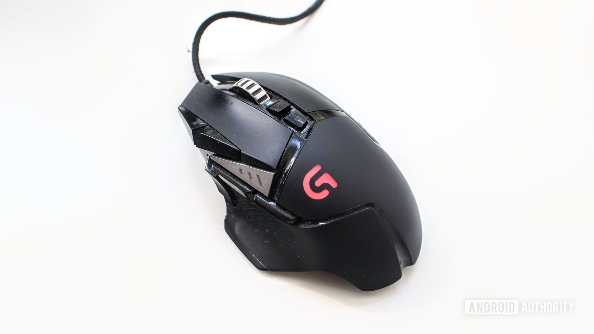logitech g502 mouse on a white table