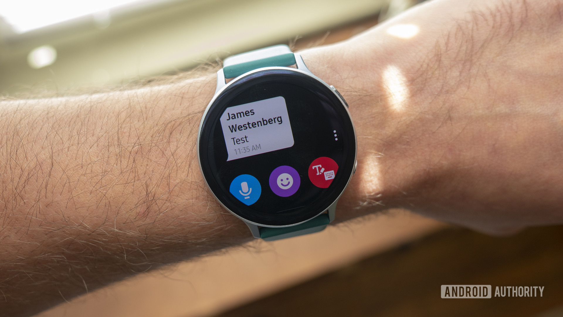 A Samsung Galaxy Watch Active 2 displays a user's text notification.