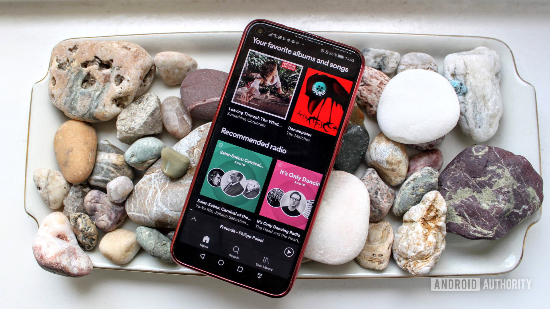 Spotify menu on a smartphone on a bed of rocks