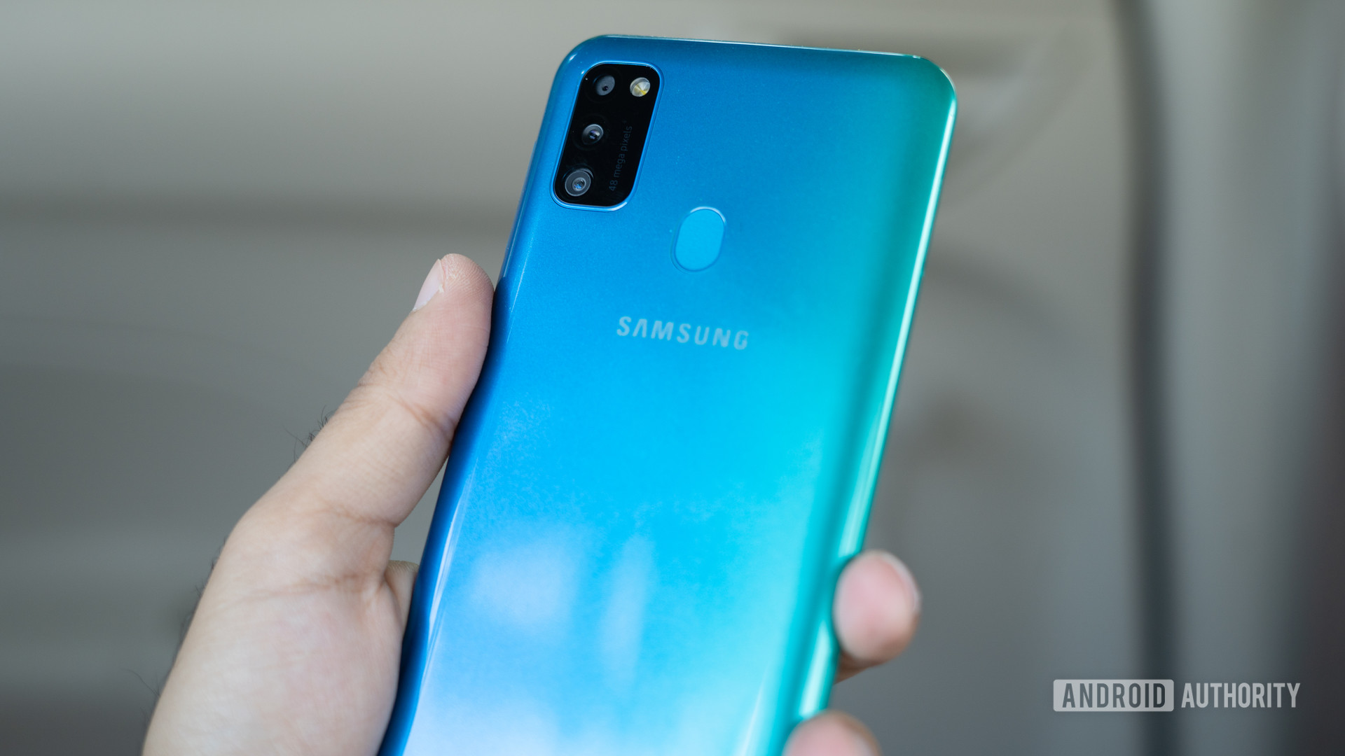 Galaxy M30s in hand with gradient and cameras
