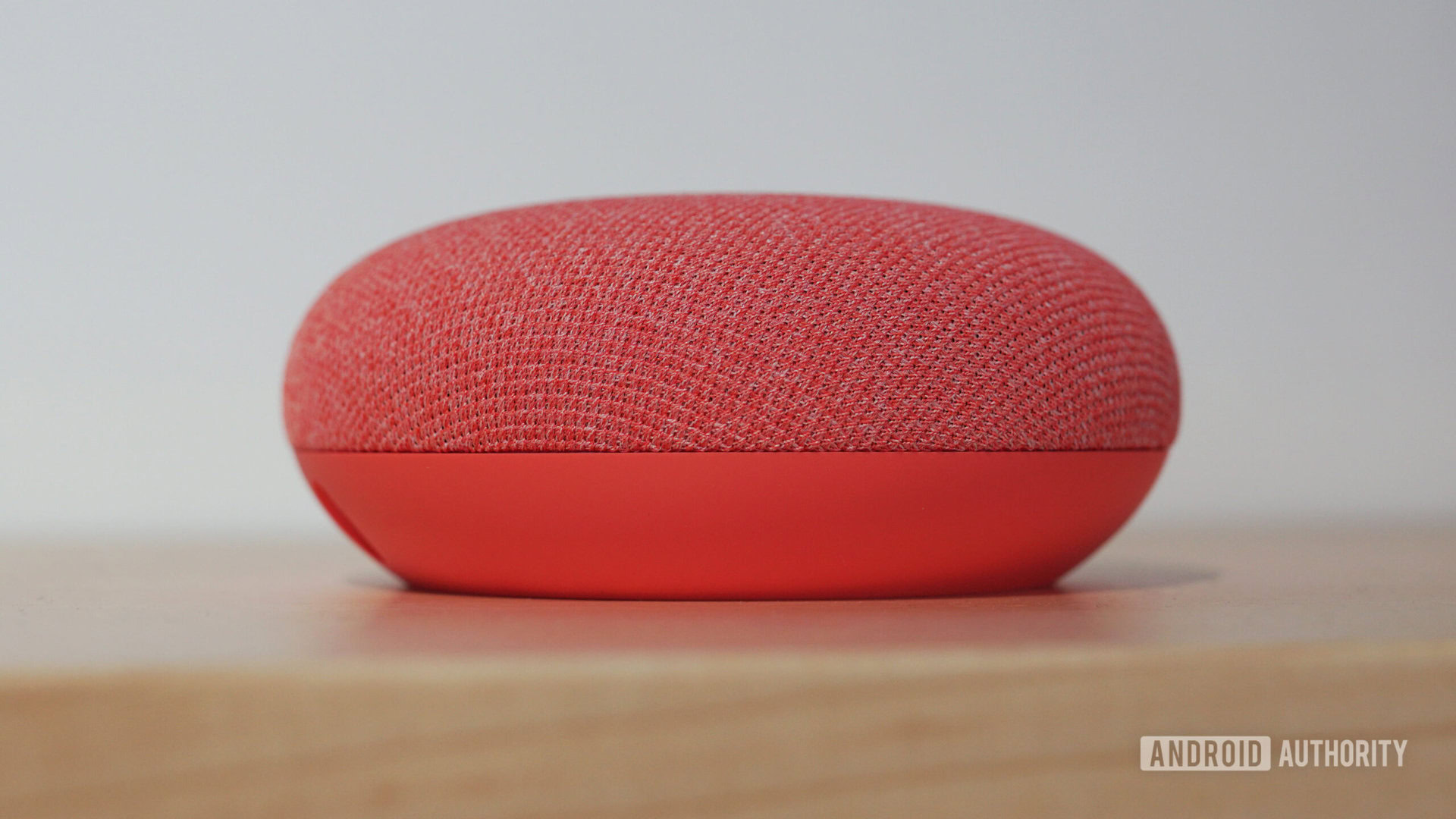 Google Nest Mini closeup in Coral color