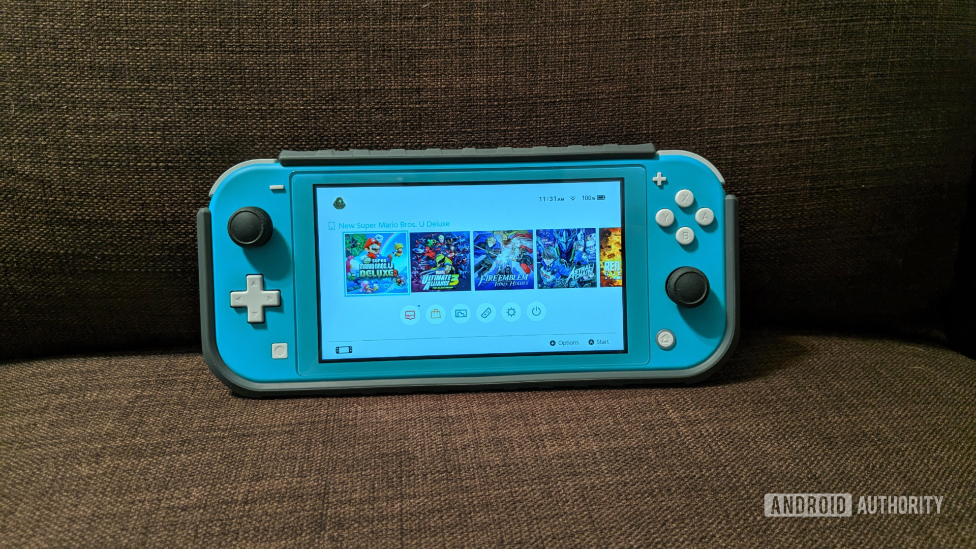 Nintendo Switch Lite on a sofa - one of the best travel gadgets