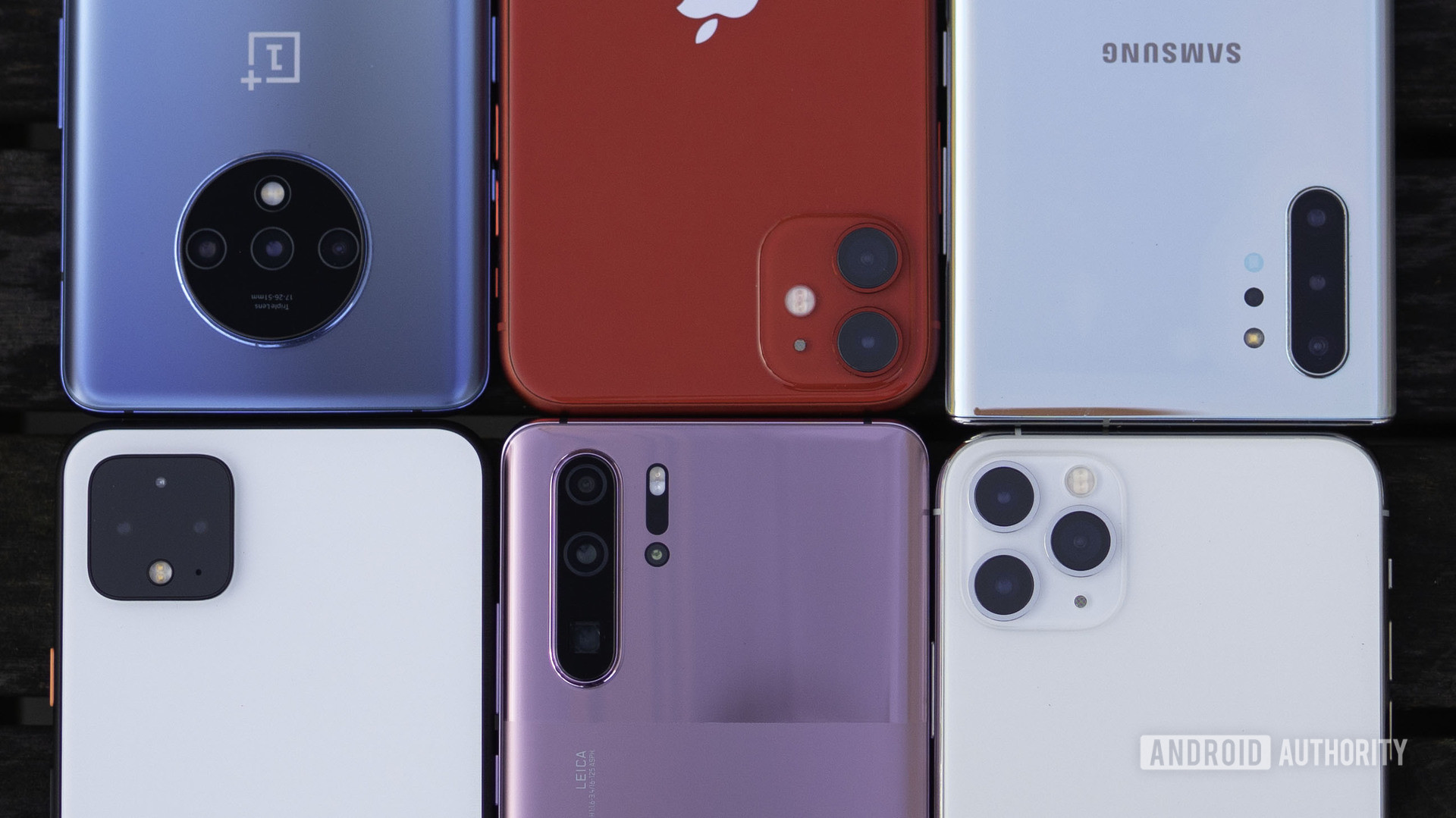 Phone storage space comparison - OnePlus 7T, iPhone 11, Google Pixel 4, Huawei P30 Pro, iPhone 11 Pro, Samsung Galaxy Note 10 Plus face down on a table
