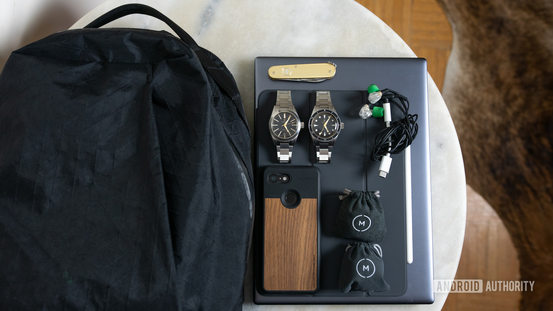 A backpack, Pixel 3 phone, two watches, and other daily essentials that Adam always uses.