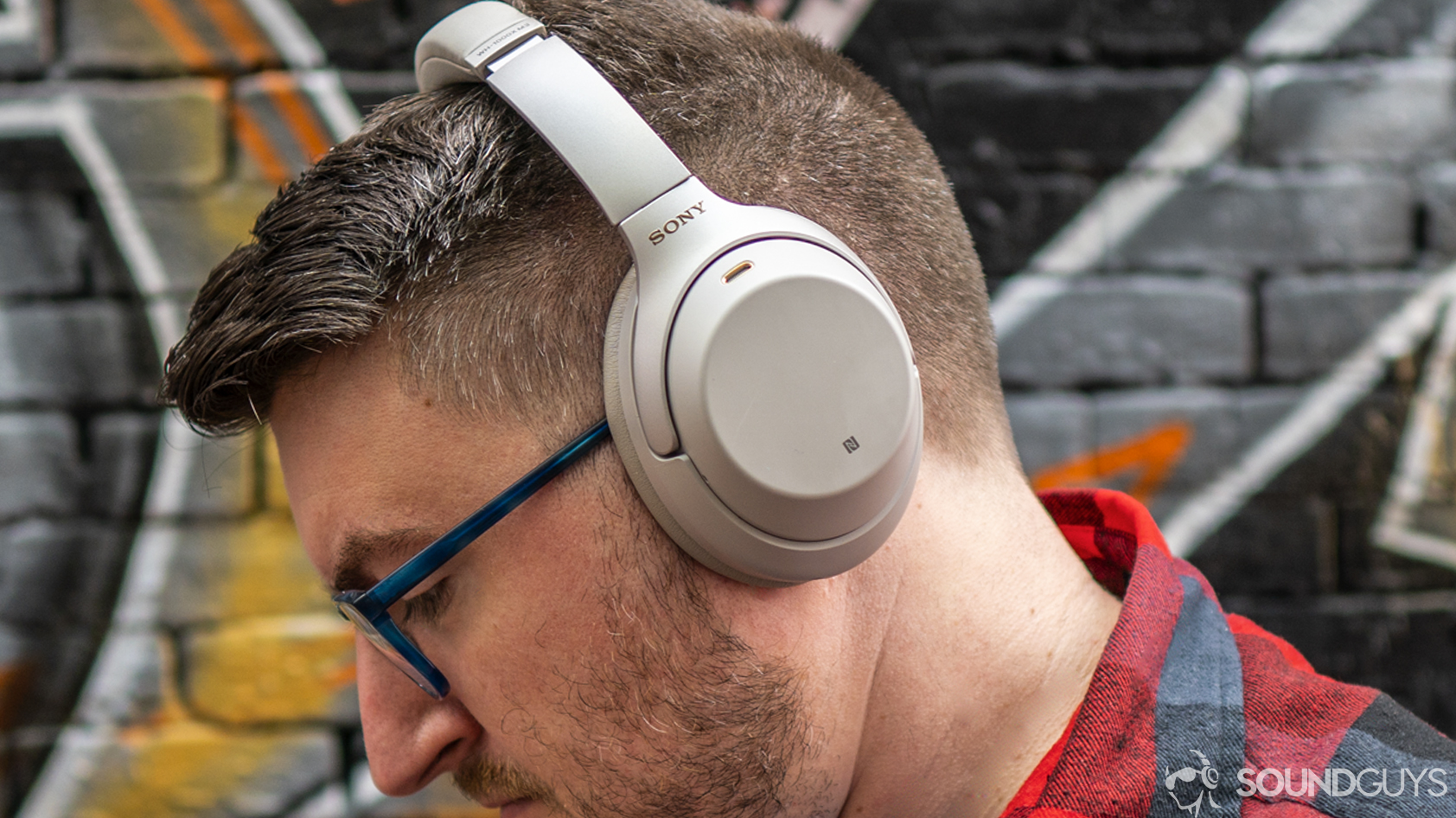 A photo of a man wearing Sony WH-1000XM3 headphones.